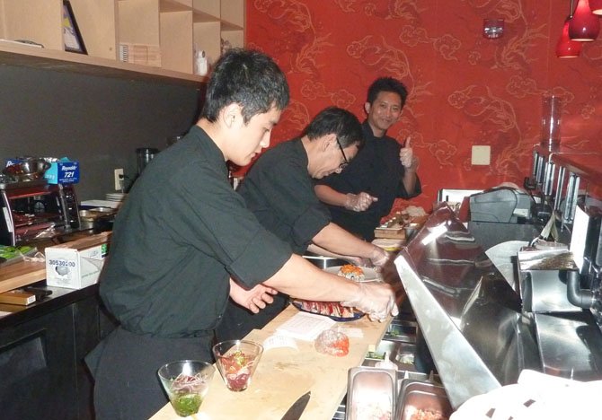 Master sushi chef Saran “Peter” Kannasute, right, gives a thumbs up during the soft opening of The Sushi Bar May 31 in Del Ray. The adults-only restaurant officially opened June 4 on Mount Vernon Avenue.