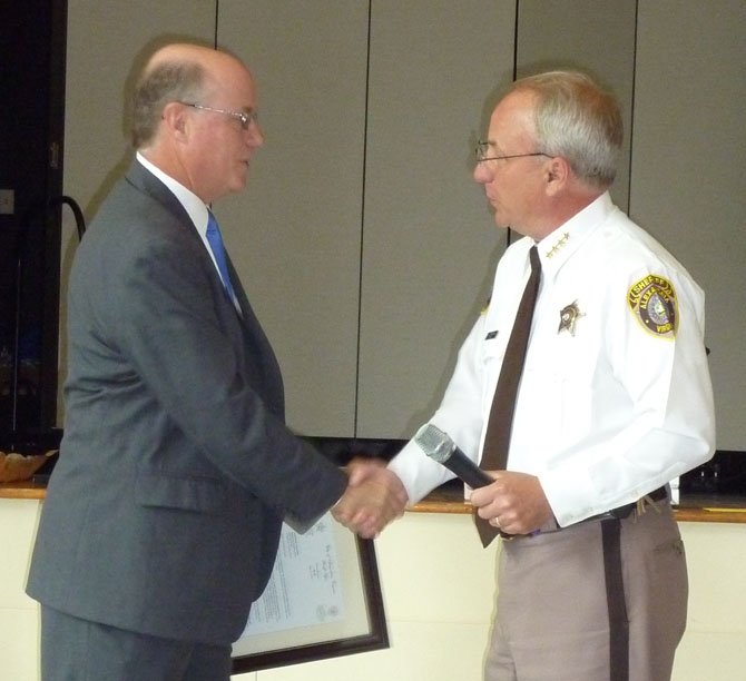 Sheriff Dana Lawhorne, right, congratulates Tony Davis on his retirement as undersheriff at a luncheon held June 3 at the Durant Center.
