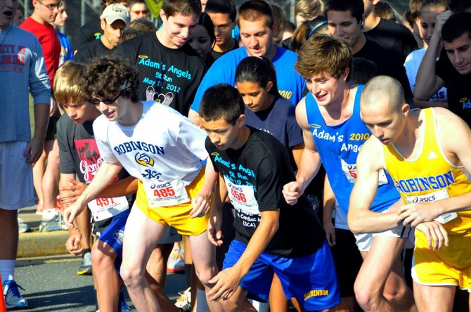 Runners take off from the startling line of last year's Adam's Angels 5K race.