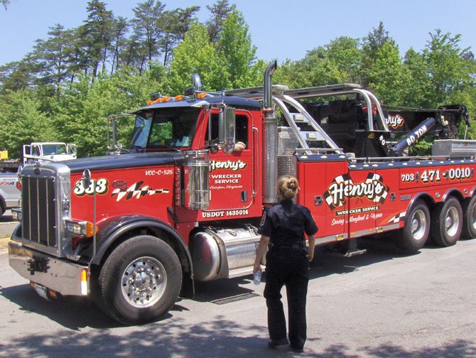 Fairfax County Police Det. C.C. Snyder, with the Crash Reconstruction Unit, approaches the driver of an incoming tow truck.