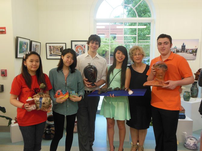 Holding their creations, Centreville High artists at the Clay Connection awards ceremony are (from left) Stephanie Truong, Jiyae Han, Jordan Axelrod, Mary Do, teacher Rory Marcaccio Schaffer and Christian Hall.