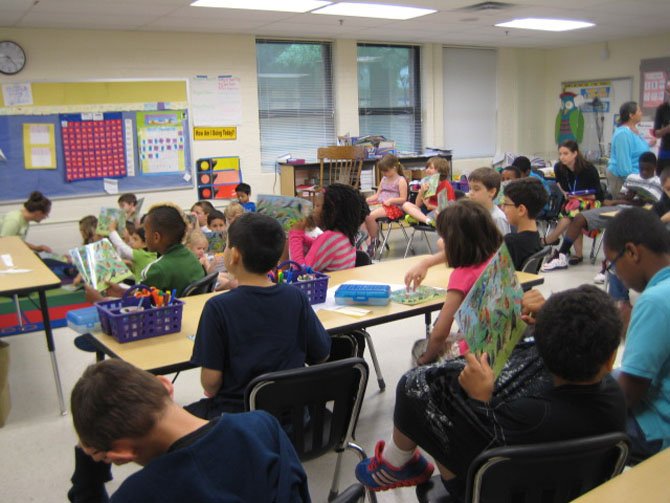 Ms. Sherry’s second grade class studies their bird identification guides.