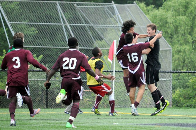 Teammates celebrate with Lucas Belanger, right, after the Mount Vernon goalkeeper made the game winning save in a penalty-kick shootout against Cosby in the state championship game on June 9 at Westfield High School.
