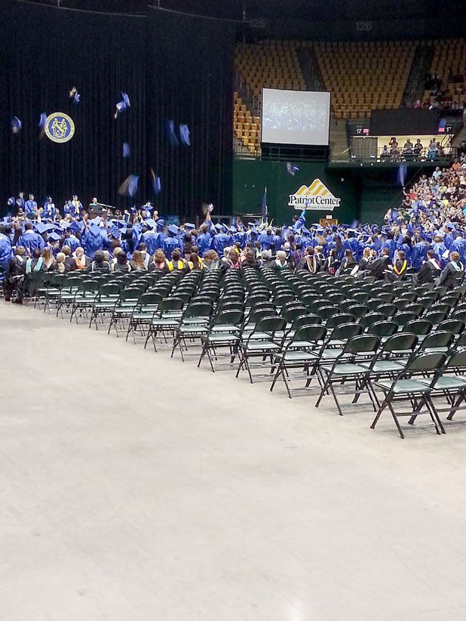 Lee seniors toss their caps in the air in celebration as they are officially announced as graduates of the school.
