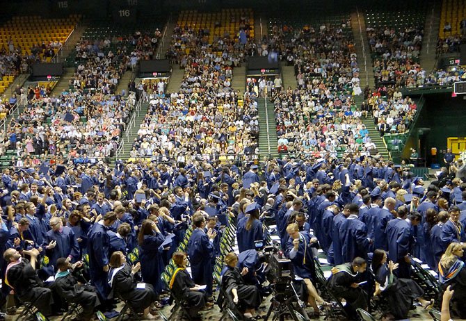 Graduates of South County High School’s Class of 2013 celebrate their commencement by throwing their caps in the air.
