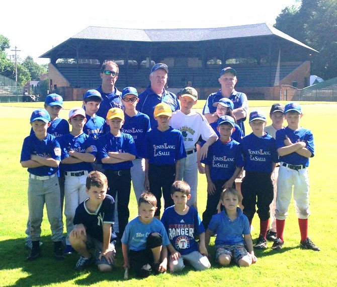 Alexandria Little League players visit historic Doubleday Field in Cooperstown, N.Y. last weekend. Shown (back row, standing, fron left): coaches Paul Kopp, Bob Mannell, and Gus Chiarello; (middle, standing, from left) players Will Kopp, Oliver Barwell, Evan Sarchio, Jack Reardon, Zachary Bosland, Brenham Daniell, Cooper Bosland, Gus Chiarello, Michaela Mannell, Baden Reynolds, Ethan Bauman, Ethan Reynolds and Peter Chiarello; (kneeling, from left) "batboys" Branson Daniell, Keenan Reynolds, Walker Kopp and Charlie Barwell. 
