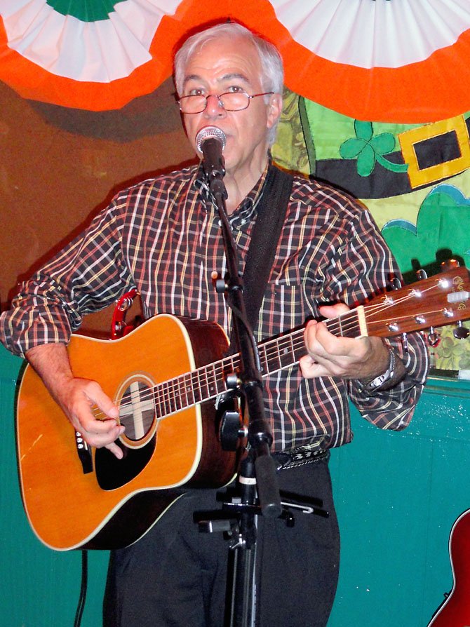 Jim Bellas, 65, performs on vocals and guitar at Kate’s Irish Pub Open Mic Night in Springfield.