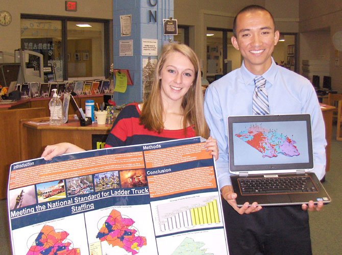 Kelsey Ciarrocca and Steven Yu with a poster of her GMU project and his 3D map showing the locations of Iowa’s existing water wells, the rock types and water depths. 