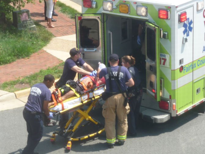 Station 17 paramedics prepare to place an injured man inside an ambulance.
