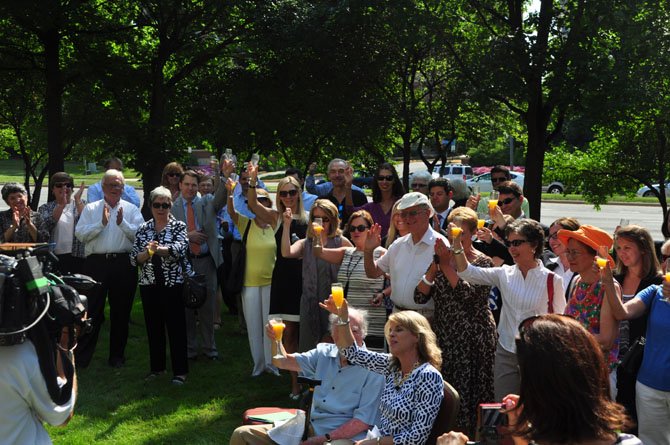 Supporters of the Initiative for Public Art-Reston, toast to the latest project Wednesday, June 26 at Reston Town Center. 