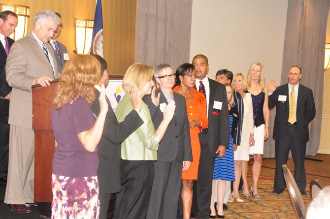 Del. Tom Rust (R-86) swears in the new board of the Greater Reston Chamber of Commerce Thursday, June 27. 