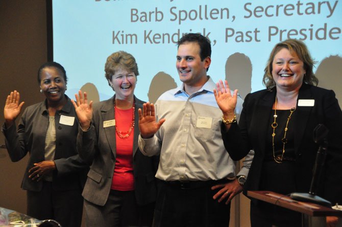 From left, Belinda LaValle, Barb Spollen, Mark Dolfis and Denise Miller are sworn in Tuesday, June 25 as the Fiscal Year 2014 board for Shelter House. 