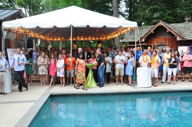 Guests duck the rain at the annual Northern Virginia Technology Council Hot Ticket Awards in McLean Wednesday, June 26. 