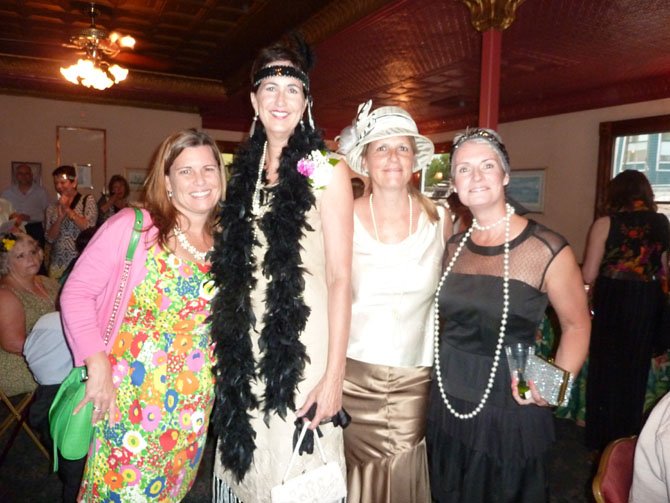 Cathy Puskar, Jane Hess Collins, Callie MacKenzie and Jane Hughes get in the Great Gatsby spirit at the 10th anniversary Fostering the Future cruise aboard the Cherry Blossom June 27.
