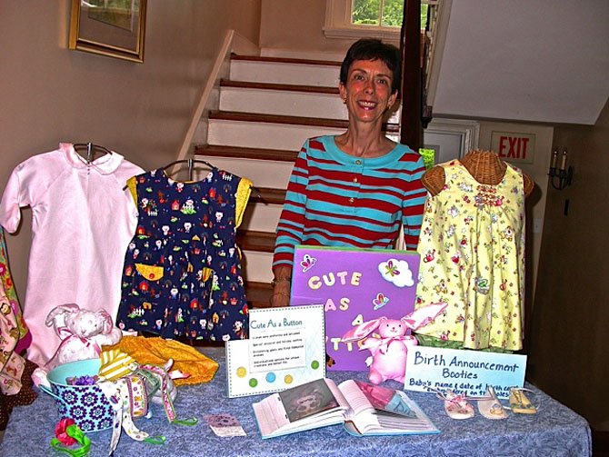 Rhianna Demson shows some of her children’s clothing.