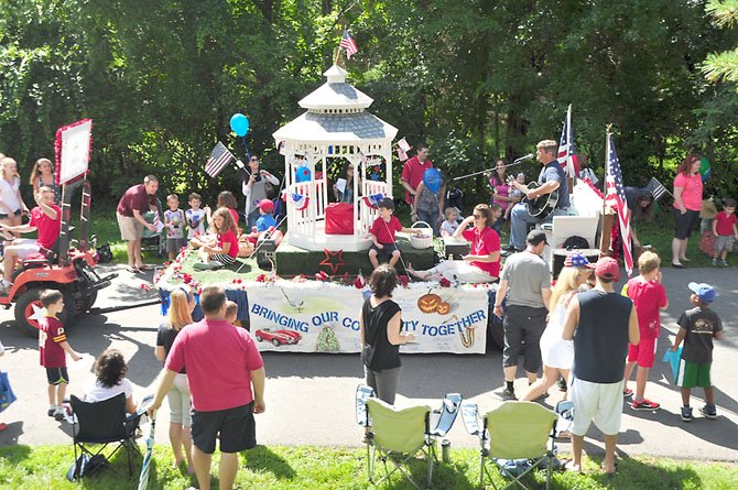 The Celebrate Great Falls float makes its way down Columbine Street during the annual Great Falls Fourth of July parade. 