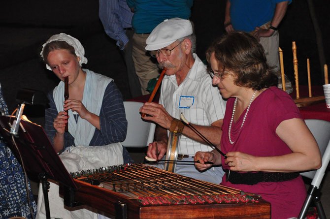 From left, Emma Dodd, Craig Packard and Joan Dubinsky play colonial music at the Claude Moore Colonial Farm 40th anniversary Thursday, July 11. 