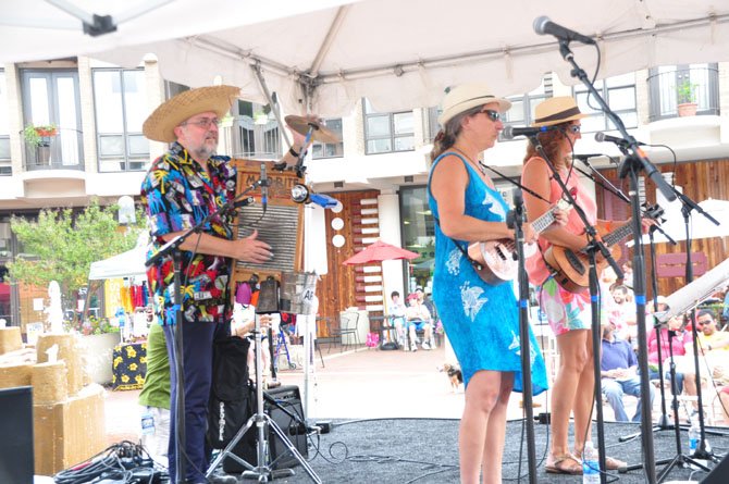 Pat Quinn, Gina DeSimone and Ron Goad perform at Lake Anne during the Northern Virginia Ukulele Festival Saturday, July 13. 