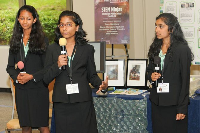 Team STEM Ninjas (from left) Sneha Thandra, Divya Mereddy and  Rachana Subbanna present their project at the national competition. 