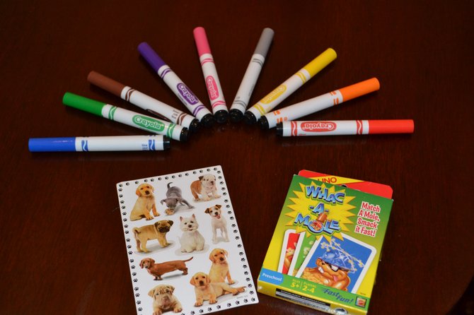 When packaged creatively, flashcards, stickers, paper and crayons can entertain children during long trips.