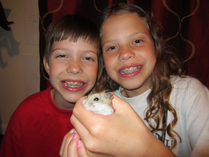 Rose and Gloria Boos with Chip the hamster (the lone survivor). Both girls are 9 years old, attend Great Falls Elementary School and are rising fourth graders.