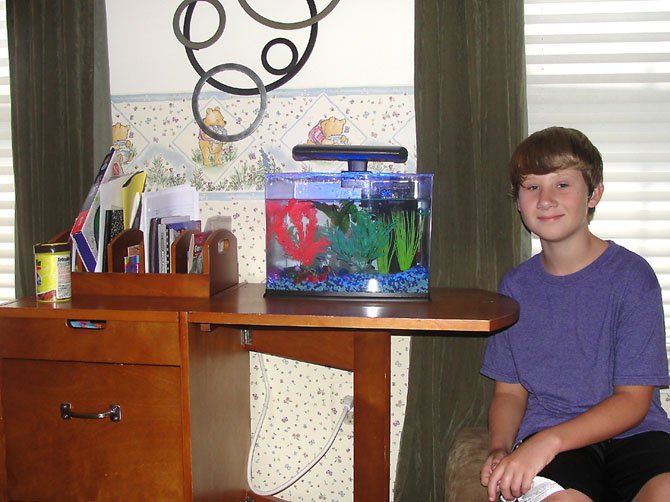 Carson Stewart poses with his fish tank.