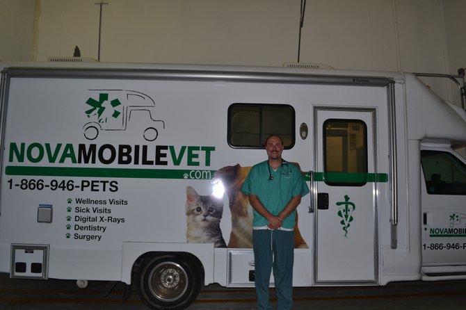 Eric Cryan beams outside his Nova Mobile Vet van in Lorton.