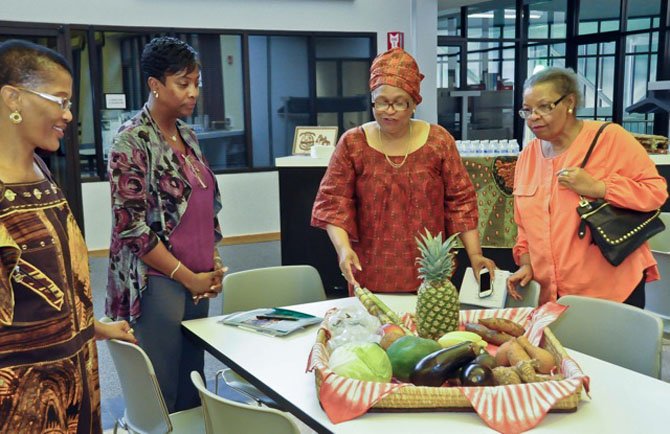 Trypetus Cooper Padmore, founder of Hinds Feet Ministries, welcomes visitors to the 15th anniversary of the ministry at the Reston Community Center. 