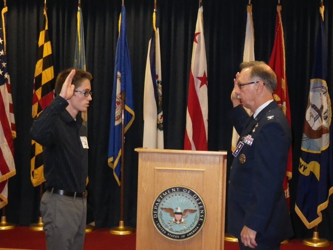 Administering the Enlistment Oath—Marine Recruit Brandon A. Clifner and Colonel Dennis J. Rensel, USAF (ret).