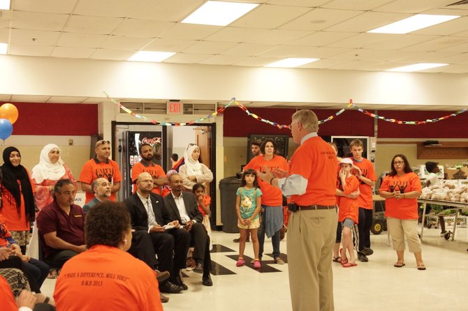 Supervisor John Foust (D-Dranesville District) addresses the Herndon Without Hunger volunteers before the start of the first of four food distribution events during Ramadan. Foust has been a long-time supporter and volunteer at the charitable event.