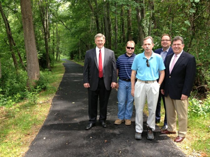 From left, Supervisor John Foust (D-Dranesville), Bill Boston, Fairfax County Park Authority project manager, Kirk Holley, park authority manager with the Special Projects Branch, Planning and Development Division, David Bowden, director of the park authority’s Planning and Development Division; and Dranesville District representative to the Fairfax County Park Authority Board Kevin Fay at a newly-completed extension of trail that connections Churchill Road to Ingleside Avenue.