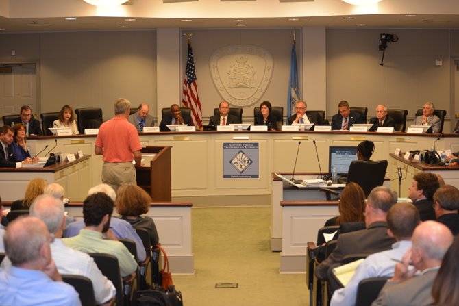 The members of the Northern Virginia Transportation Authority listen to testimony during the public hearing portion of their meeting on July 24. Twenty-one speakers addressed the Authority before the members proceeded to vote on a list of transportation projects to be funded and initiated in FY2014.