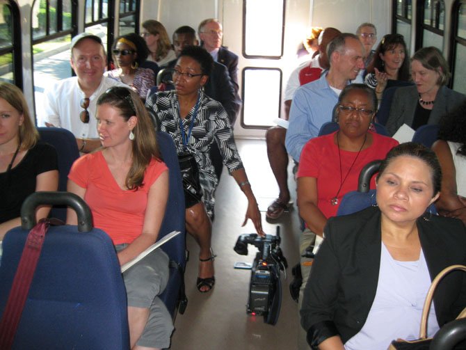 Members of the media and invited guests take a bus tour of the Mount Vernon Pyramid neighborhoods.