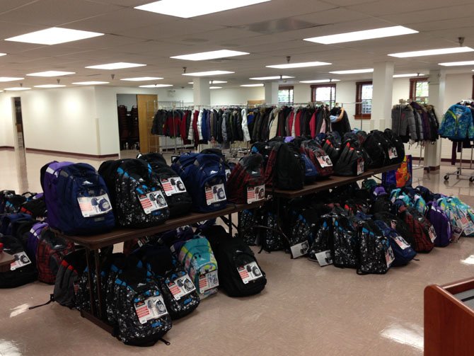 Donated items include backpacks, clothes and school supplies.