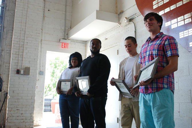 Families and friends celebrate as apprentice of 10 months Nashell Dennis , apprentice of  4 months Coby Stewart, apprentice of 8 months Juan Carlos Henriquez and apprentice of 5 and a half months Anthony Ness receive their certificates during the apprentices graduation ceremony at the Alexandria Seaport Foundation on July 26.

