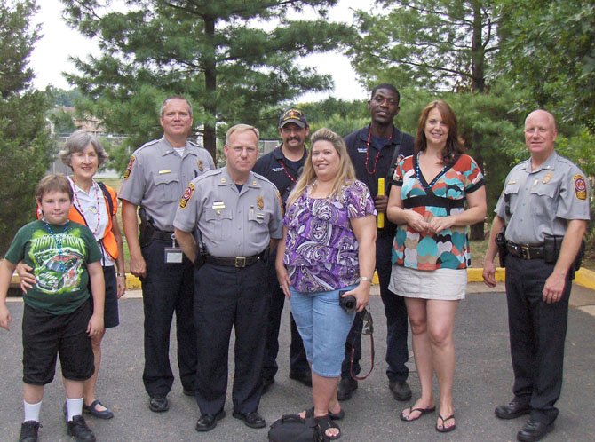 Enjoying National Night Out in Sully Station II in August 2011 are (front row, from left) Jesse and Rose Plowchin, Lt. John Trace and Capt. Purvis Dawson of the Sully District Station, Kim Hines, Laura Elder and then Deputy Chief of Patrol E.C. Roessler; and (back row, from left) Paul Fraraccio and Eugene Larty of West Centreville Fire Station 38.
