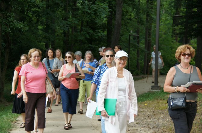 A group of MPAartfest artists stroll through McLean Central Park as part of their MPAartfest artist orientation.