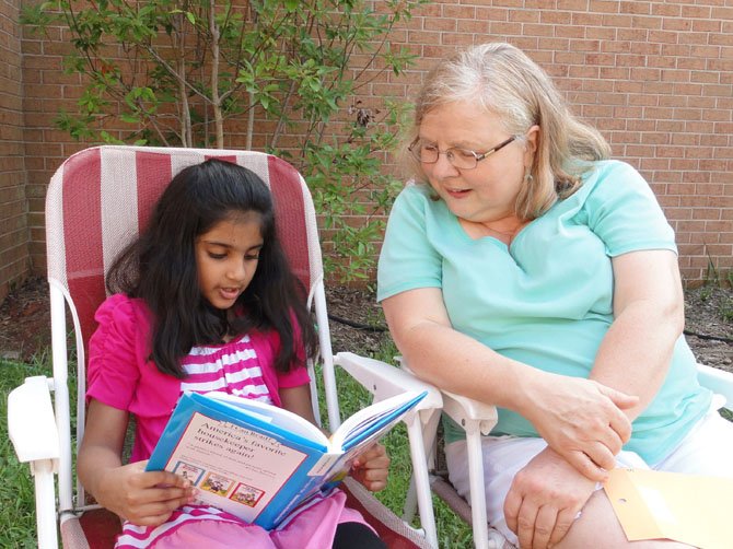 Rising second-grader Iman Asim reads “The Adventures of Amelia Bedelia” with CPC volunteer Darlynne Gendreau.