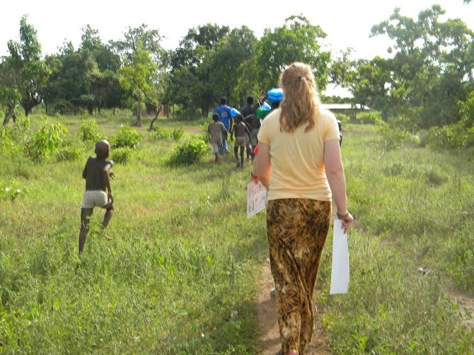hannon Wilkinson, walking through the village with some of the little children to hand out the nets and the instructions on how to use them.
