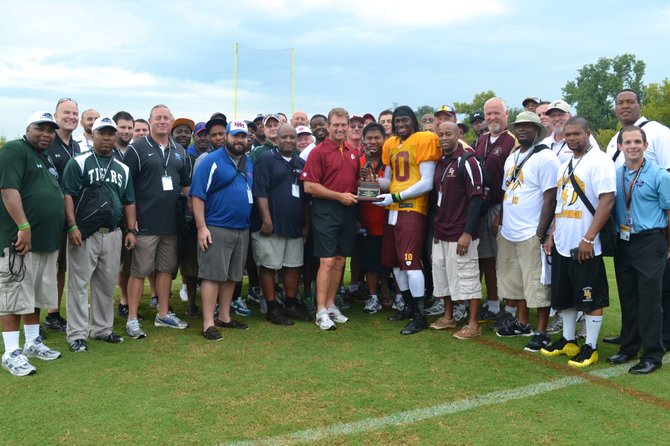 The coaches at the Washington Redskins High School Coaches Clinic, along with Redskins QB Robert Griffin III and Redskins legend, Joe Theismann. Theismann presented Griffin III with the Quarterback Award from the Quarterback Club of Washington.