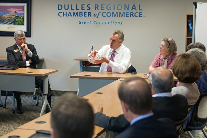 Members of the Dulles Regional Chamber Board of Directors listen as Democratic gubernatorial candidate Terry McAuliffe, center, discusses his top priorities for the commonwealth if he wins this year’s election. Also pictured: Don Owens, left, chairman of the chamber’s board of directors, and Eileen Curtis, right, the chamber’s president and CEO.