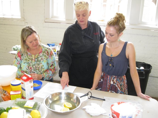 (From left): Terry Holman, chef Kathleen Linton and Catherine Boyd, all of Lorton, discuss Old Bay tofu fishcakes.