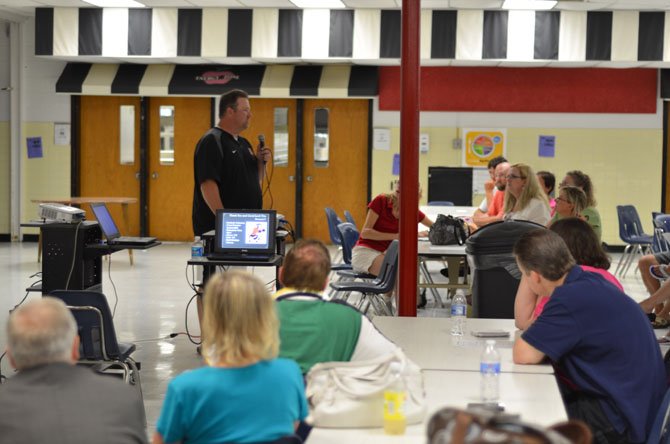 Parents listen to speakers at Herndon High Coaches' Night at the school cafeteria.
