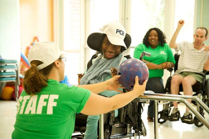 Alyssa Florwick, deputy respite director for Potomac Community Resources, with a PCR member.