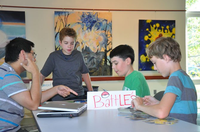 From left—Oakton resident and Madison High School graduate Timothy Foley volunteers as an adult leader and advisor; Forestville Elementary School student Michael Gatti initiated and organized the effort to bring to Great Falls the kind of Pokemon program that Foley had established in Vienna; Kilmer Middle School student Liam is earning community service hours for eighth grade and his national engineers’ honor society; and Toren Tuthill, a Forest Edge Elementary School student from Great Falls.
