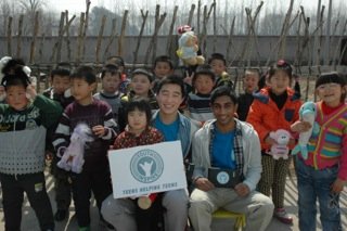 Youth Inspire leaders Jason Cui and Ezzy Sriram in the rural outskirts of Beijing implementing tablet computers in a primary school curriculum.
