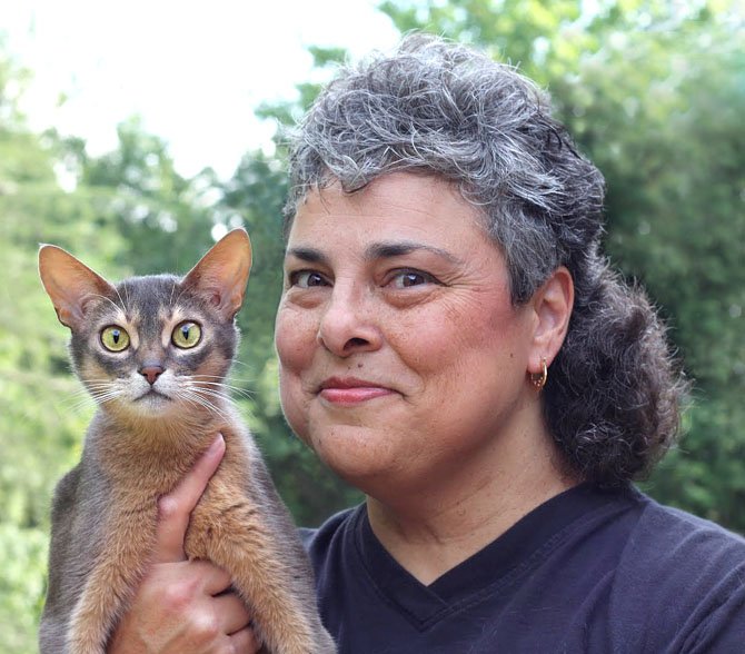 Lisa-Maria Padilla, 52, of Reston with her Abyssinian cat, Racy Mooner, at the National Capital Cat Show at the Dulles Expo Center in Chantilly over the weekend, Sept. 7-8.