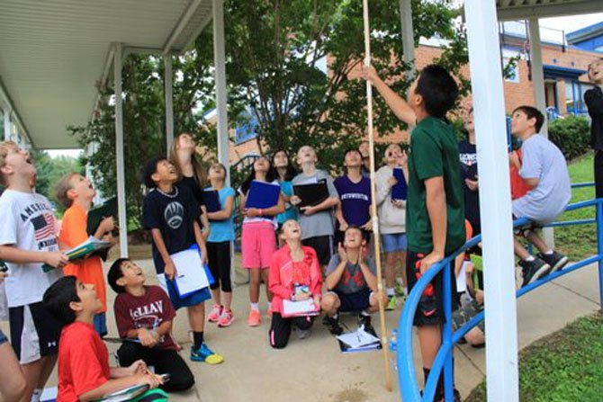 Churchill Road sixth graders were forced to launch their Alka-Seltzer rockets under the school’s awning as a result of inclement weather. From left: Ethan Hsaio, Armin Taheripour, Connor Hohl, Colin Arner, Sun-Ho Oh, sixth grade teacher Chrissy Frantz, Stepanie Bi, Elena Moy, Megan Vandre, Caitlin Cunningham, Will Wheat, Spencer Brooks, Ashley Zu, Dora Wu, Ulia Ahn, Brandon Torng, Jackson Greehan and Massimo Frix.
