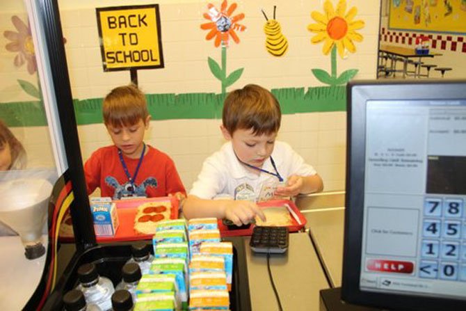 Even though it was only the first week of school, Churchill Road kindergarteners Billy Center and Max Brooke were already experts at entering their PIN to pay for lunch.
