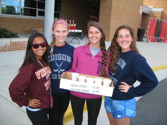 Edison High field hockey team members (from left): Robyn Palompo, Emily Jarmin, Danielle Hook and Natalie Hartzell sell sno-cones and cotton candy for their fundraiser.
